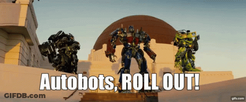 Transformers Standing In Front Of Building With Autobots Roll Out GIF