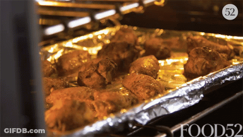 Tray Of Food In Oven With Number 52 GIF