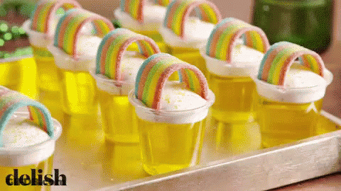 Tray Of Jelly Cups With Rainbows Saying Delish GIF