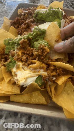 Tray Of Nachos With Guacamole And Cheese GIF