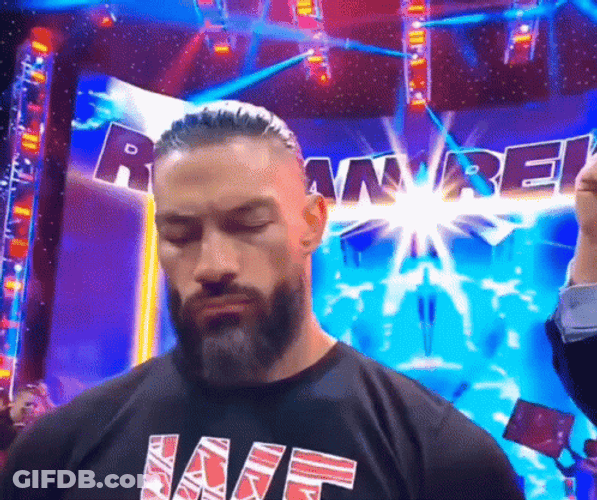 Tribal Chief Roman Reigns Closing Eyes And Smirks GIF