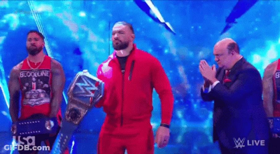 Tribal Chief Wearing Red Suit Raising Belt GIF
