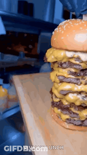 Triple Cheeseburger On Wooden Cutting Board GIF