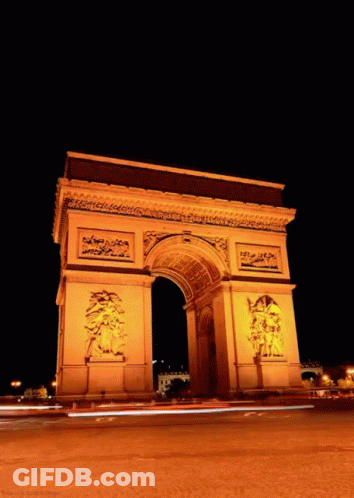 Triumphal Arch Lit Up At Night With Cars GIF