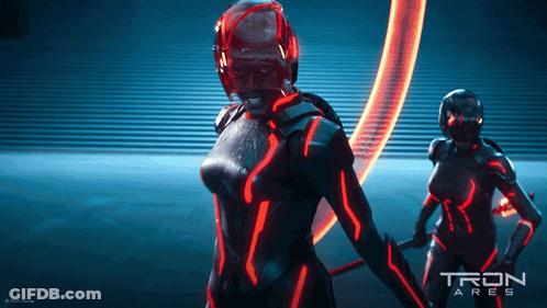 Tron Ares Poster With Two Women In Futuristic Costumes GIF
