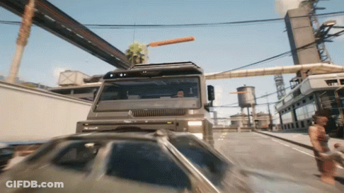 Truck Driving Down Street With Car Behind GIF