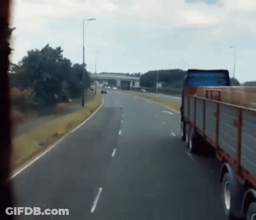 Truck Driving On Highway Next To Car GIF