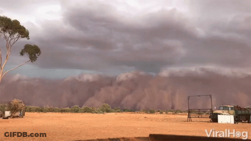 Truck Parked In Dirt Under Cloudy Sky GIF