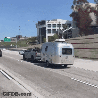Truck Pulling Airstream Trailer On Freeway GIF
