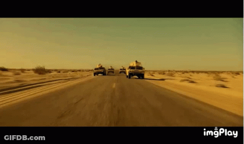 Trucks Driving On Desert Road GIF
