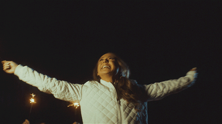 Turning Around Holding Sparklers GIF