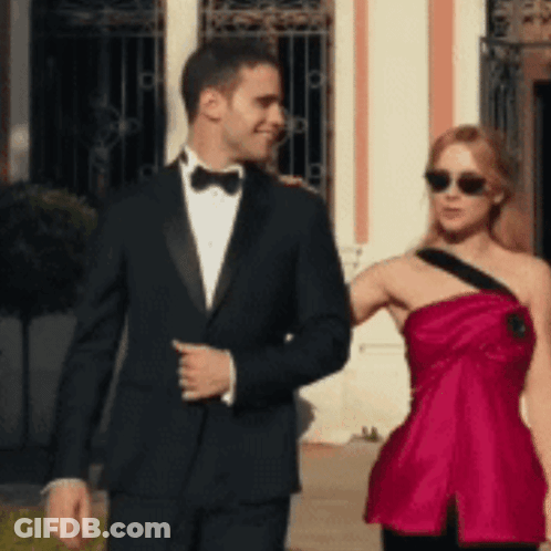 Tuxedo Man And Red Dress Woman Walking GIF