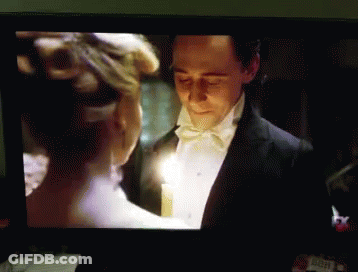 Tuxedo Man Holds Candle With White Dress Woman GIF