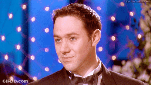 Tuxedo Man On Blue Background With Lights GIF