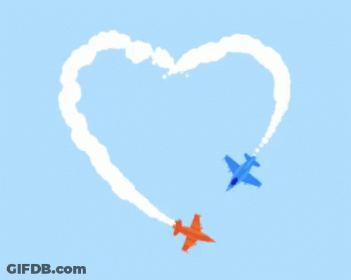 Two Airplanes Are Flying Through A Heart Shaped Cloud Formation GIF