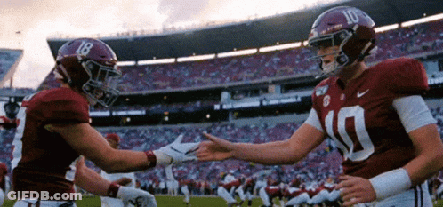 Two Alabama Football Players Shaking Hands GIF