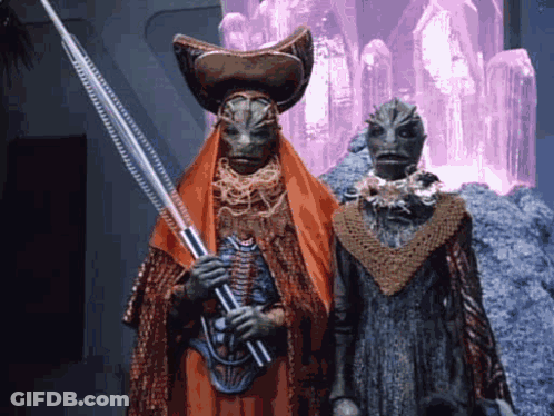 Two Aliens One Holding Spear GIF