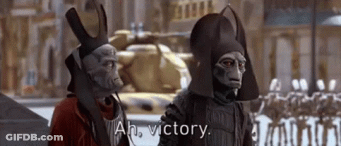 Two Aliens Standing Together Talking About Victory GIF