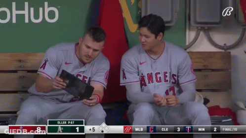 Two Angels Baseball Players Sit On A Bench Looking At A Tablet GIF