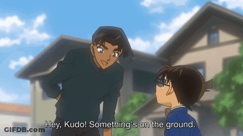 Two Anime Characters Are Standing Next To Each Other With The Words Hey Kudo Something 'S On The Ground Below Them GIF