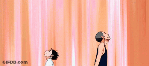 Two Anime Characters Standing, One Smiling GIF