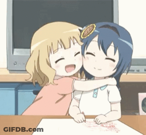 Two Anime Girls Are Hugging Each Other At A Table In Front Of A Television . GIF