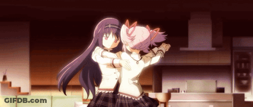 Two Anime Girls Are Hugging Each Other In A Living Room GIF