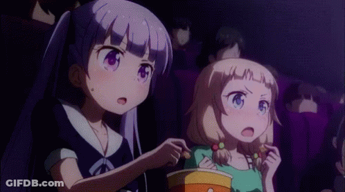 Two Anime Girls Are Sitting In A Movie Theater Eating Popcorn And Watching A Movie . GIF