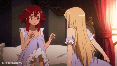 Two Anime Girls Are Sitting On A Bed And One Has Red Hair GIF
