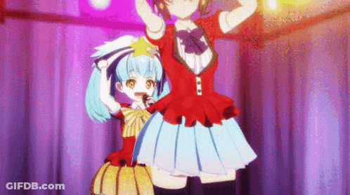 Two Anime Girls Are Standing On A Stage With Their Arms In The Air GIF