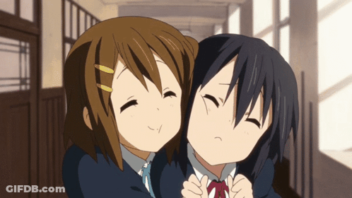 Two Anime Girls Hugging Each Other In A Hallway With Their Eyes Closed GIF