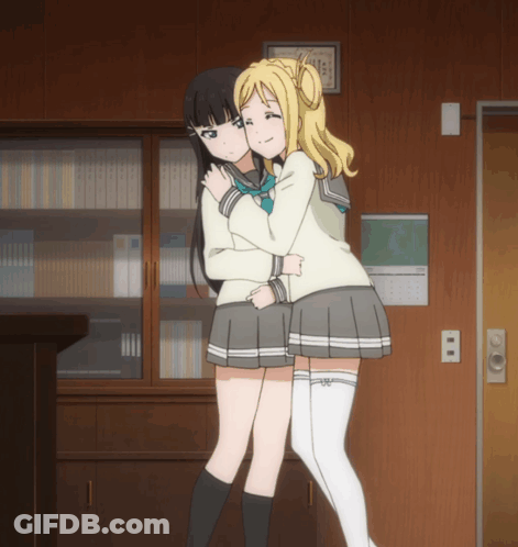 Two Anime Girls Hugging In Front Of Calendar GIF