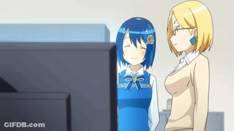 Two Anime Girls Standing Next To Each Other In Front Of A Tv GIF