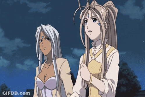 Two Anime Girls Standing Next To Each Other With One Having A Blue Circle On Her Forehead GIF