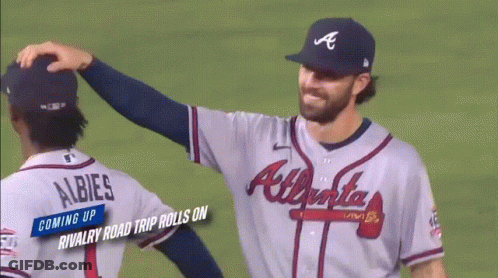 Two Atlanta Braves Baseball Players Are Hugging Each Other GIF