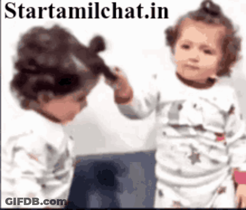 Two Babies Are Brushing Each Other 'S Hair In Front Of A Mirror With The Website Starttamilchat.in In The Corner GIF