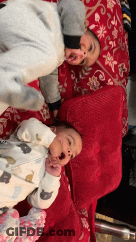 Two Babies Lying Next To Each Other GIF
