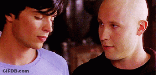Two Bald Men Are Looking At Each Other In A Close Up GIF