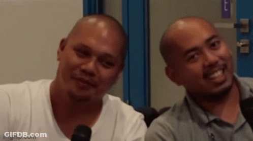 Two Bald Men Smiling Beside Microphone GIF
