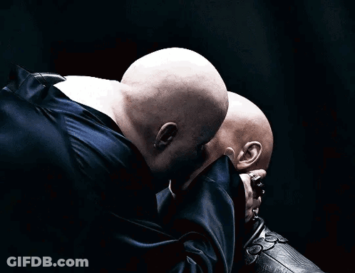 Two Bald Men Touching Each Other's Faces GIF