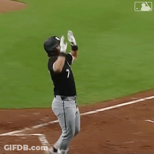 Two Baseball Players Are Celebrating A Home Run On A Baseball Field GIF