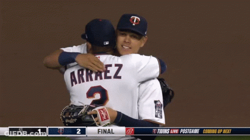 Two Baseball Players Are Hugging Each Other And One Has Arraez On His Jersey GIF