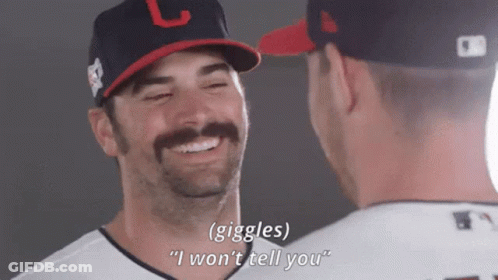 Two Baseball Players Are Laughing And One Of Them Is Wearing A Hat With The Letter L On It GIF