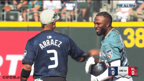 Two Baseball Players Are Shaking Hands During A Game Sponsored By Fox GIF