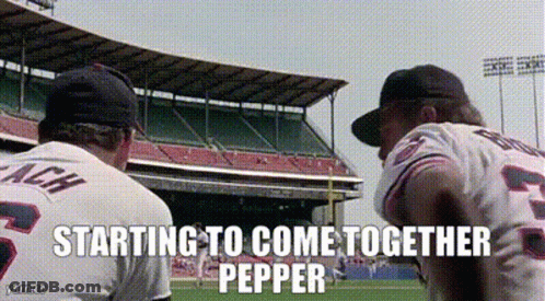 Two Baseball Players Are Standing On A Field With The Words Starting To Come Together Pepper GIF