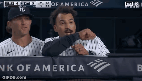 Two Baseball Players Behind A Bank Of America Banner During A Game GIF