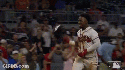Two Baseball Players Celebrate In Front Of A Crowd With A Mlb Logo In The Corner GIF