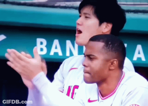 Two Baseball Players Clapping In Front Of Ban Sign GIF