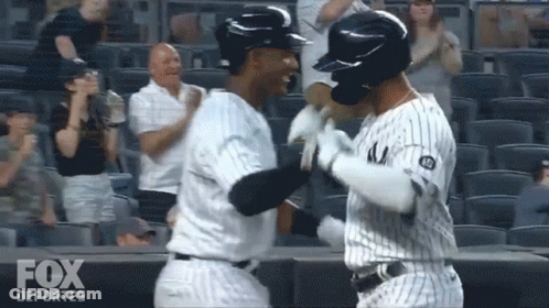 Two Baseball Players Hugging Fox Deportes Logo GIF