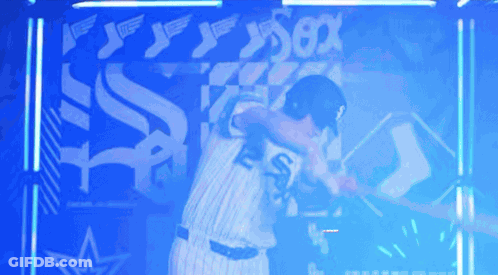 Two Baseball Players Hugging In Front Of Sox Sign GIF